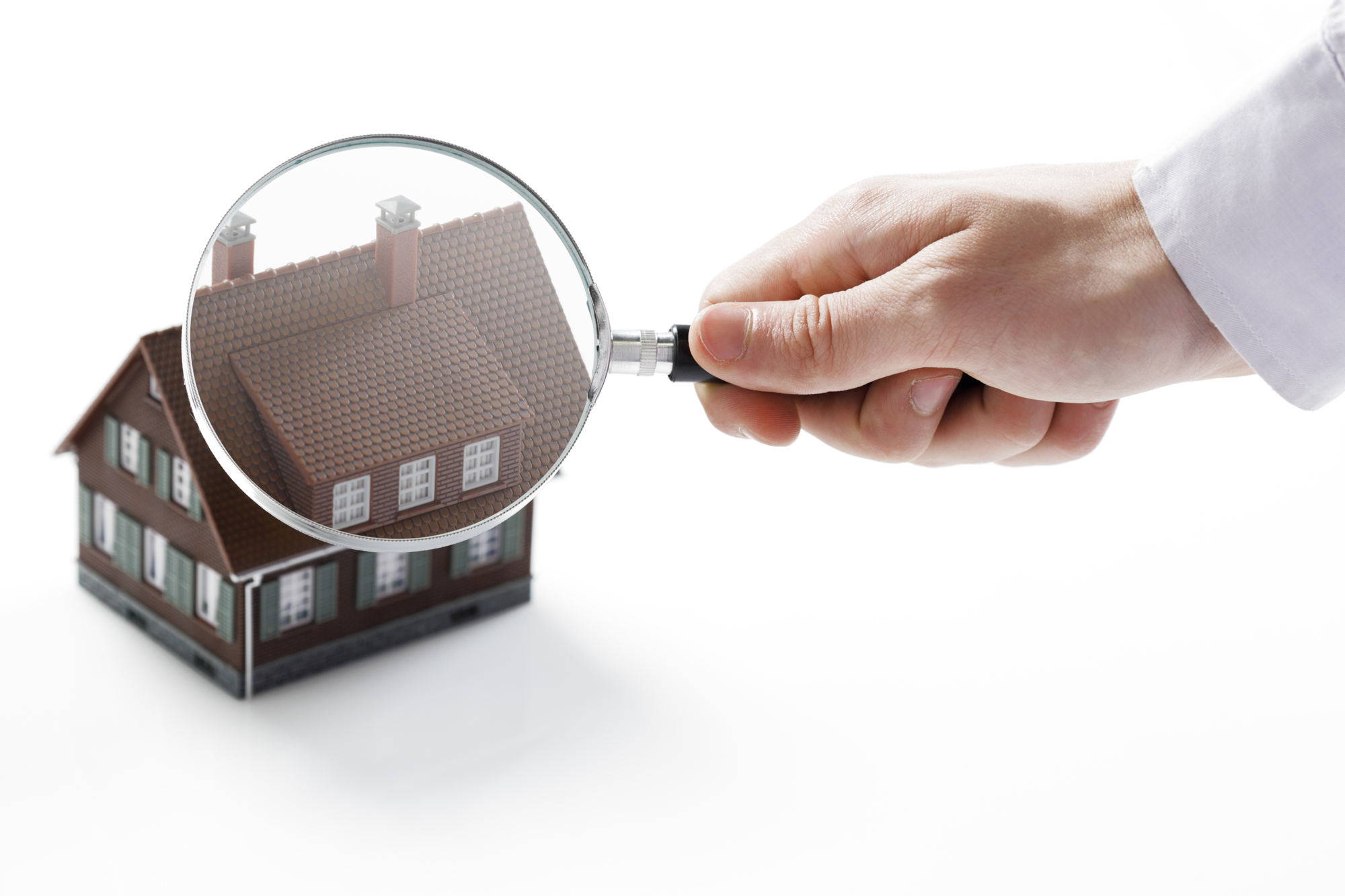 Magnifying glass and house.