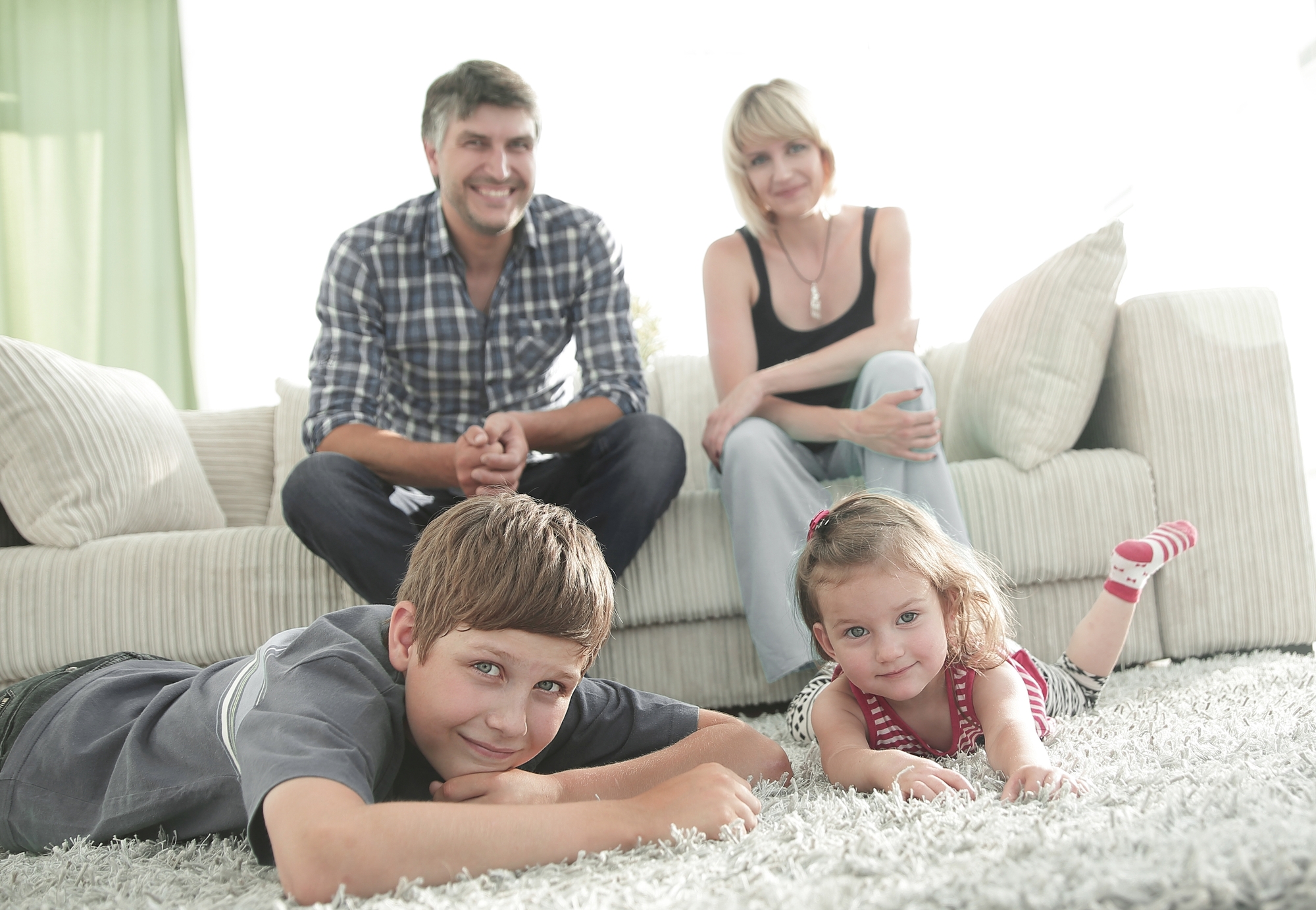 Portrait of happy family sitting together in living room