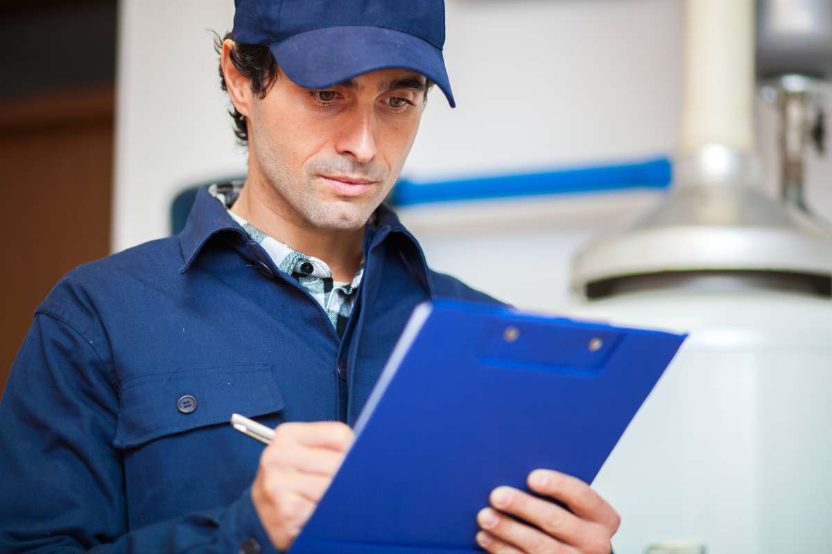 Technician fixing an hot-water heater